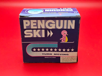 Tin plate skiing penguin with original box