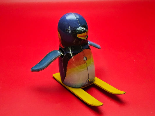 Tin plate skiing penguin with original box